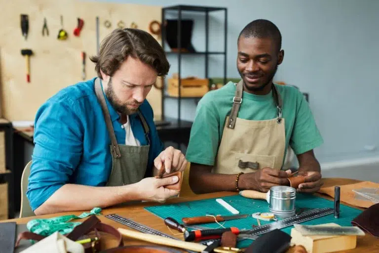 Image of two males engaged in a DIY project, with one providing instruction to the other