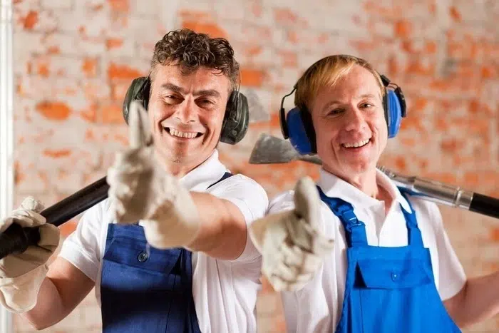 Two happy men working together on a basic DIY project at home